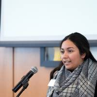 A woman standing at the podium speaking.